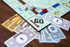 CALDWELL IDAHO/USA - MARCH 16 2015: Game of monopoly with cash thrown about near the collect go section