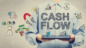 Cash Flow Concept With Young Man Holding A Tablet