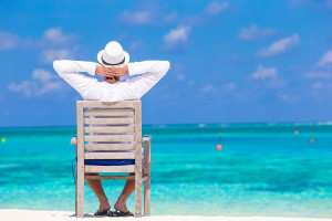 Young happy man enjoying summer vacation on tropical beach