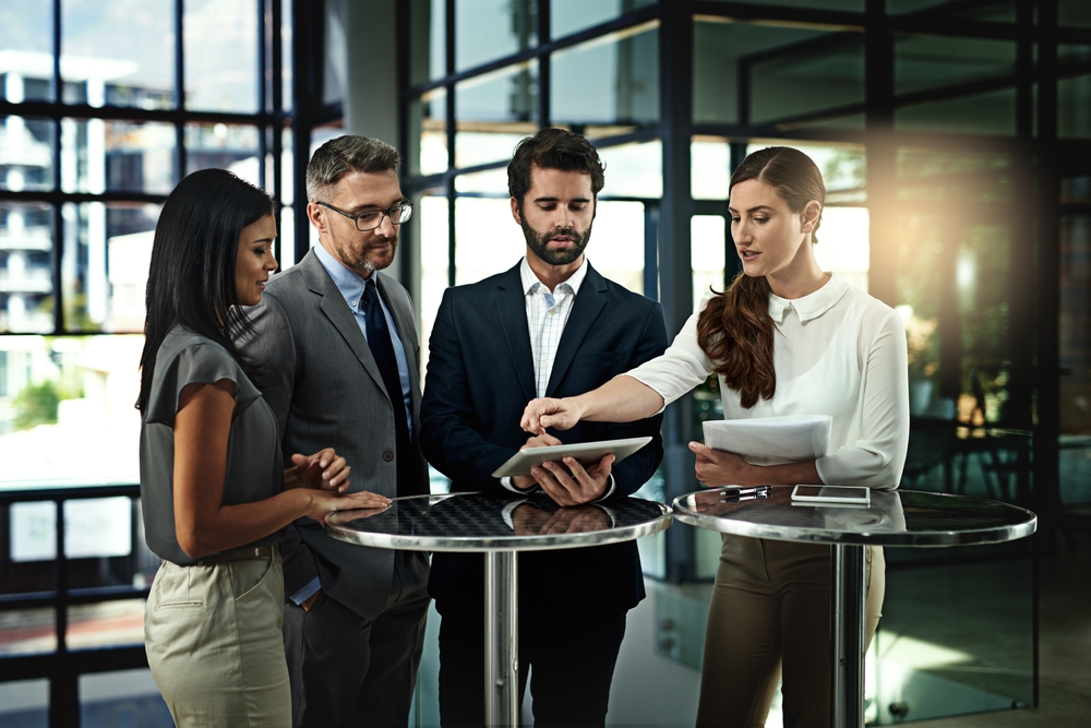 Corporate leaders working together to align business goals through cultural transformation consulting in a modern office environment.
