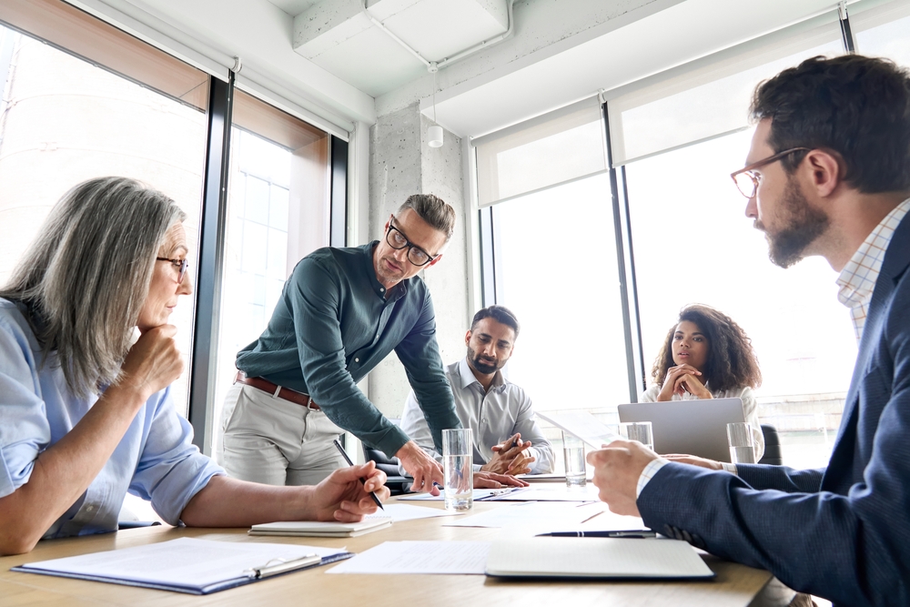 Business professionals reviewing ideas and strategic plans with cultural transformation consulting to build a more collaborative and high performing organization.
