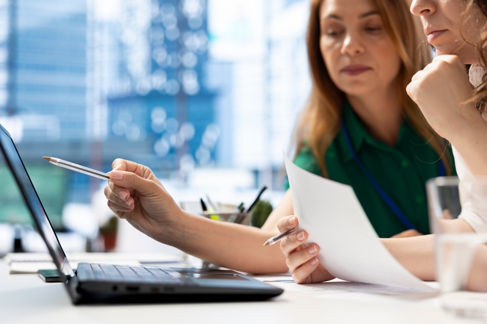 Business professionals collaborating in a modern office while exploring innovative ways to attract talent through workplace culture and recruitment strategies.