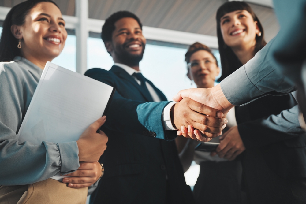 Business colleagues collaborating around a conference table while planning an employee experience strategy for a more connected and engaged workforce.
