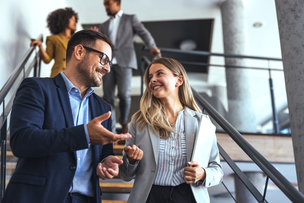 Leadership team working together in a modern office to develop an effective employee experience strategy that enhances employee wellbeing and productivity.
